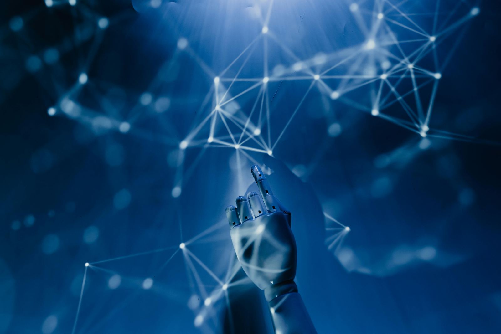 Robotic hand reaching into a network of connected data points