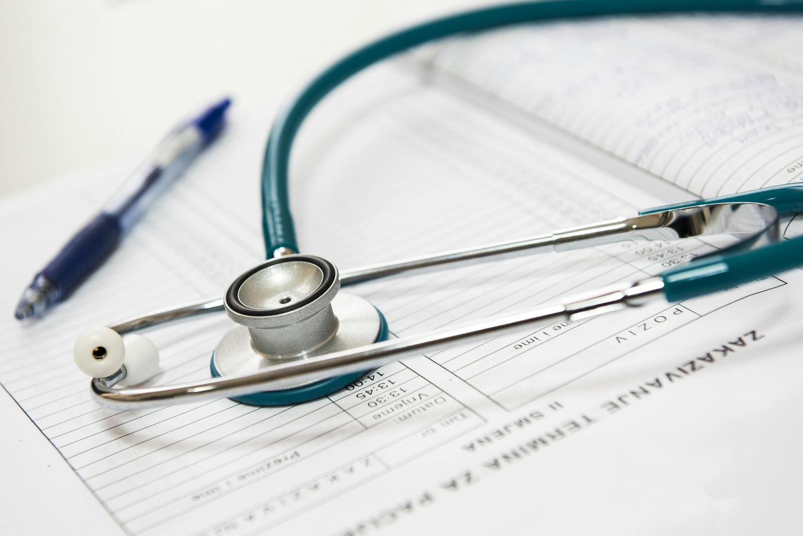 Stethoscope resting on a patient appointment schedule